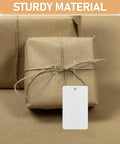 Blank White PVC Hanging Tags With Lanyard Waterproof 100 Pcs Jewelry Display Labels on brown wrapped packages.
