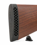 Close-up of Grind-To-Fit Recoil Pad For Rifles And Shotguns, Silicone Buttstock Pad In Black on wooden rifle stock.