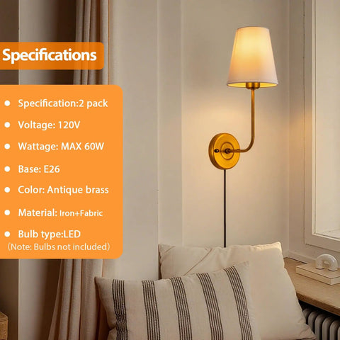 Antique brass wall sconce with white shade next to a window and cushions, 2-pack, plug in or hardwired, 120V, E26 base.