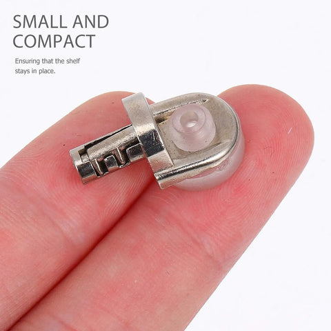 Close-up of silver shelf peg from 20 Pack Zinc Alloy Shelf Pins With Rock Solid Grip And Easy Install held between fingers