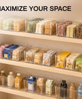 Clear Pantry Organizers And Storage Bins With Quick Adjust Dividers, Super Sturdy Fridge Containers for kitchen shelving filled with snacks.
