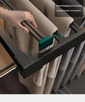 Close-up of Expandable Trouser Rack Slim Drawer Organizer holding trousers, showcasing pull out hooks for easy access.