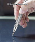 Hand using scribing pen from 4 Pack Tungsten Carbide Scriber Tool Set With Magnet, Pro Grade Metal Engraving Pen on smooth surface