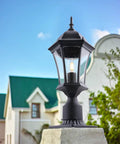 Outdoor Post Light Fixture With Pier Mount, 20-Inch High Matte Black Lantern With Clear Seeded Glass on stone base.