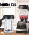 Clear Blender Jar With Blade Lid Replacement, 64 Ounce Transparent Container For Smoothies And Sauces, Compatible With G Series Blenders And 5300, BPA Free, Durable High Quality, Easy Pour Measurements next to a blender base with smoothie