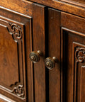 Close-up of antique brass Top Tier Zinc Alloy Cabinet Knobs And Drawer Pulls on vintage wooden cabinet doors.