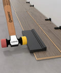 Pro DIY Ready Flooring Installation Kit For Vinyl Laminate And Hardwood Floors With hammer and tapping block in use