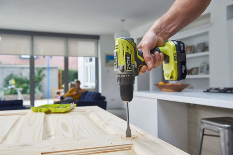 High Output 18V Cordless Drill Driver With 22 Torque Settings And Self Tightening Chuck, drilling into wood.