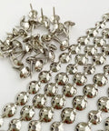 Five Meter Upholstery Tack Strips Featuring Nine Point Five Millimeter Nickel Finished Heads And Included Single Nails laid out.
