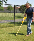 Man using a Rugged Magnetic Locator With Slick One-Handed Ergonomic Grip And Dead On Digital Readout for underground detection.