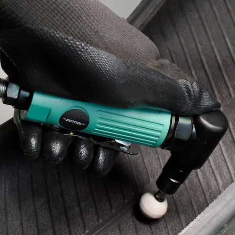 Bad Boy Pneumatic Right Angle Die Grinder Cranking 22000 RPM for swift grinding held in gloved hand on rubber surface.