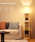 Floor Lamp With Shelves Modern Square Standing Shelf Light in living room, lit with warm LED, books and decor on shelves, corner view.