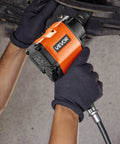Shop Ready 1 2 Drive Pneumatic Impact Wrench Unleashes Killer 738 Ft Lbs of power gripped in gloved hands, working on a car.