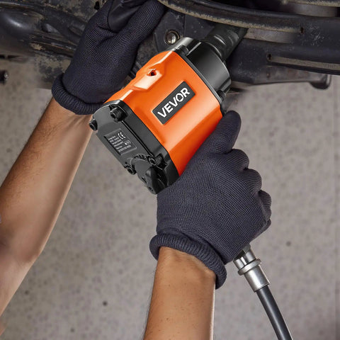 Shop Ready 1 2 Drive Pneumatic Impact Wrench Unleashes Killer 738 Ft Lbs of power gripped in gloved hands, working on a car.