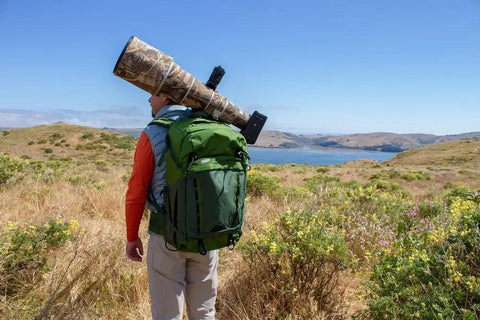 BackLight 36L Outdoor Adventure Camera Daypack Backpack in Woodland Green on hiker with camera gear, overlooking scenic view