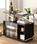 Movable Glass Cabinet Side Table with Wheels, multi-layer shelves, glass front, in living room setting with decor items on top