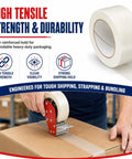 Beefy Five Point Five Mil Fiberglass Reinforced Packing Tape Rock Solid Rubber Resin Adhesive For Heavy Duty Shipping And Cardboard Box Bundling One Inch By Sixty Yards Pack Of Two Dozen on a box being sealed.