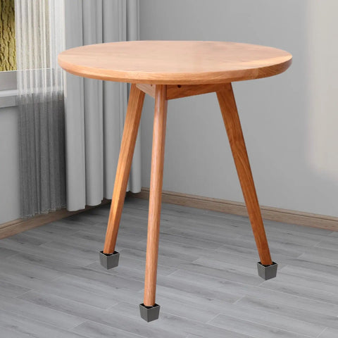Round wooden table with square legs featuring Four Pack Square Furniture Legs For Sofa And Cabinet, Black Metal And Plastic.
