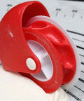 Red portable pastry wheel with white cutting wheel for lattice pie crust.