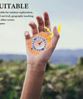 Hand holding Pocket Orienteering Compass With Map Scale Built From Durable Acrylic For Precise Readings in a natural setting.