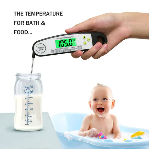 Hand using digital meat thermometer for grilling with backlit display over milk bottle, baby in tub nearby