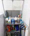 SuperLift Pull Down Closet Rod System with gray finish and back wall mount brackets, holding cleaning supplies above shelving.