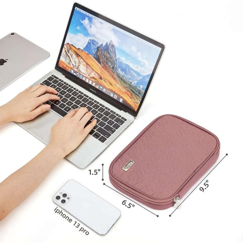 Hassle Free Travel Cable Caddy For Tech Gear And Electronic Accessories Featuring Huge Capacity Custom Pockets 9.5x6.5x1.5 inches next to laptop.
