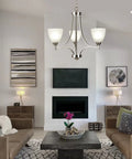 Three Light Dope Sleek Contemporary Chandelier In Brushed Nickel With White Glass Shades in stylish living room setting