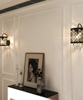 Crystal Wall Sconce Set Of 2 Indoor Wall Lamps With Lattice Drum Shade For Bedroom Bedside Living Room Black Finish Durable Solid Metal Construction Slick Modern Home Decor mounted on a white wall next to artwork.