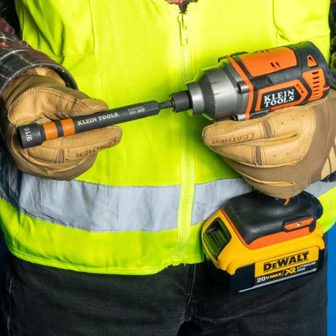 Person holding a tool with a ratcheting impact rated hollow power nut driver set with handle, magnetic and color coded, 9/16 inch size.