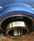 Thinking Process: single steel industrial rolling bearing set in blue housing for motor and fan shafts