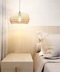 Real Deal Plug In Pendant Light Featuring Woven Rattan Shade And Hassle Free On Off Switch above bedside with lamp illuminating cozy bedroom.