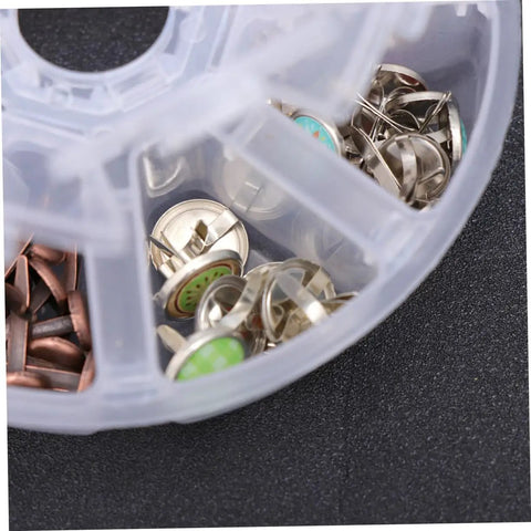 Close-up of 110 PCS Colorful Metal Brads Fasteners For Scrapbooking And Cardmaking in a clear divided container, showing assorted colors and split pins.