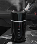Road Warrior 420ml Portable Water Heater And 12V 24V Travel Kettle on car console, displaying temperature, designed for on-the-go hot water.