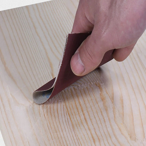 Hand using Emery Cloth Roll Set With 5 Grits 150 240 320 400 600 8 Meters Aluminum Oxide Sandpaper on wood surface