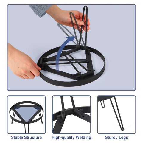 Person folding Portable Camping Tripod Stand for Bonfire Fire Pit in heavy duty iron black, showing the stable structure and sturdy legs.