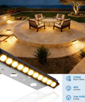 All In One Outdoor Retaining Wall Lights Kit With Transformer 2700K Warm White Hardscape Landscape Lighting IP68 Waterproof Step Lights For Patio Stairs Fence Decor 3W 8 Pack illuminating a patio area at night.