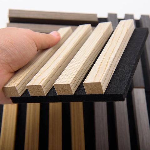 Hand holding Game Changer Acoustic Wood Slat Wall Panels for knockout noise dampening with premium polyester core.