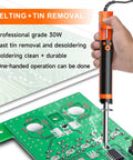 Electric Desoldering Pump Solder Sucker For Through Hole PCBs Portable Desoldering Gun With 110V Vacuum Button 1.0mm And 1.2mm Nozzles One Hand Operation in use on green circuit board