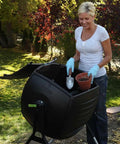50 Gallon Compost Tumbler In Black No Fuss Easy Spin Barrel For Lawn Clippings And Kitchen Scraps used by woman in garden