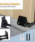 Barn Door Floor Guide With Adjustable Wall Mount For Easy Installation RV Sliding Door Guide With Screws Black Finish 2 Packs Fits Doors Of Various Thicknesses And Prevents Swinging Outward From The Wall Ideal For Cabinets And RV Trailers shown installed on wooden door with screws.