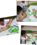 Children assembling Cool Hands On DIY Physics Lab Kit With Electromagnet And Wind Power Generator For Students outdoors on a table.