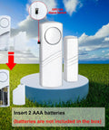 Loud Wireless Door And Window Alarm Pack displaying unit with battery insertion guide and alert switch in open field view.