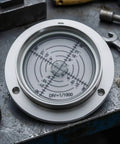 ＡＷＨＡＯ 80mm Round Spirit Level Gauge with Metal Housing and Clear for Accurate Surface Flatness Checking on Workbenches and Outrigger Systems, Style C on a workbench.
