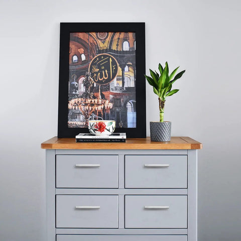 Decorated dresser with framed artwork and plant on top, featuring square 5 inch brushed nickel cabinet pulls for kitchens durable stainless steel hardware set of 60 with drill mounting template and easy install for quick upgrades on cabinets.
