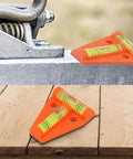 Orange T Shaped 2 Way Bubble Level For Caravan For Motorhome For Camper on a wooden surface and metal platform.