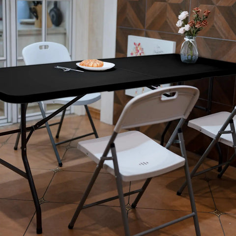 Foldable 6 Foot HDPE Table Go To Portable Banquet Surface Fold In Half Desk Utility with chairs in dining setting, black.