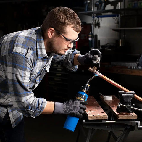 Person using Trigger Start Propane Torch For Home Projects With Webbed Flame, Easy Ignition, Versatile Soldering, Thawing, DIY tasks