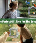 Child and dog watching birds at clear window bird feeder with ultra strong suction cups dual seed tray and water bowl.