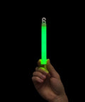 Hand holding Military Grade Glow Sticks Green 6 Inch Emergency Light Sticks SnapLight 12 Hour Duration Bulk Pack Of 20 Chem Lights